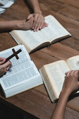 Wall Mural - Asian men and women hands praying to god with the bible. Pray for god blessing. Religious beliefs Christian life crisis prayer to god.