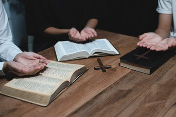 Wall Mural - Asian men and women hands praying to god with the bible. Pray for god blessing. Religious beliefs Christian life crisis prayer to god.