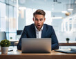 © Adrian - man working on a laptop has a look of amazement on his face