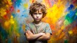© Four888 - Young boy with messy hair and dirty face, arms crossed, standing in front of a colorful background with a bold, stubborn expression on his face.