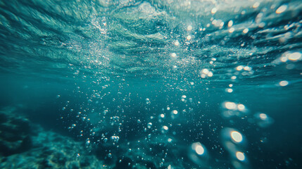 Underwater view topical turquoise water bubbles rising to surface with ripples waves rays of sunlight tranquil vacation weekend marine aquatic environmental concepts climate change