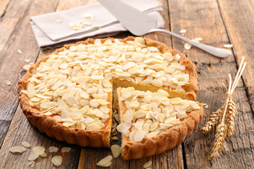 homemade cake with slice on wood background