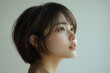 © wazamai - profile of young japanese woman with short hair in soft lighting