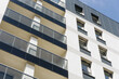 © Paweł Michałowski - Architecture background. High block of flats living area. New build neighborhood modern style. Real estate market in Europe. Blue sky high building. Condo for rent. Balconies and windows texture.
