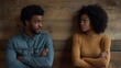 © The Little Hut - Young black indignant male gesticulating arguing with his dark skinned girlfriend who is standing against wooden wall with crossed arms looking away with deeply offended expression on  : Generative AI