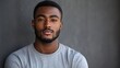 © The Little Hut - Headshot of attractive serious African student with small beard and moustache dressed in casual tshirt looking at camera with confident and thougthful expression on his face standing a : Generative AI