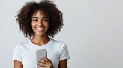 Cheerful African American with crisp hair holds modern smart phone happy to recieve message dressed in casual t shirt poses against white background with blank space for your advertise : Generative AI