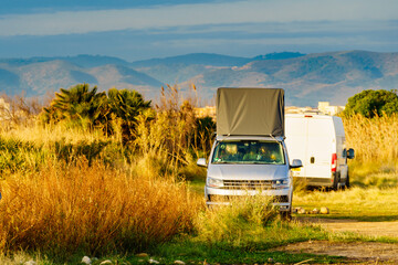 Wall Mural - Van with roof top tent camping on nature