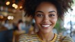 © The Little Hut - Close up shot of adorable African American woman has broad smile wears striped t shirt being in good mood rests in cafeteria with best friends Smiling dark skinned young female poses i : Generative AI