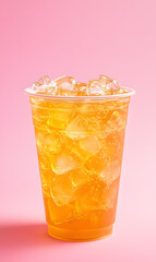 Wall Mural - Cold tea drink in plastic cup isolated on pink background