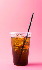 Wall Mural - Cold tea drink in plastic cup isolated on pink background