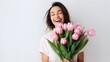 © Hordina Anastasia  - beautiful young woman laughs, holds a bouquet of tulips in her hands, spring holiday, mother, congratulation, gift, flowers, place for text, just like that, surprise, joy, relationship