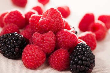 Wall Mural - Fresh raspberry and blackberry berries on white background