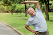 © Stella - Elderly Asian man stretching his body before exercise and jogging in a park at the morning. Happy senior exercising outdoors in green garden. Active healthy elderly workout outside in nature backyard.