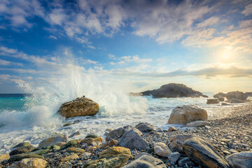 Powerful Sea waves break on big stone with beautiful white splashes