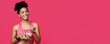 © Prostock-studio - Healthy food concept. Happy African American Fitness Lady Eating Vegetable Salad, red studio background, panorama with copy space