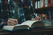 © AI Farm - A person writing in a book while studying in a cozy library environment filled with shelves of books.