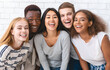 © Prostock-studio - Portrait of happy multiethnic young friends students having fun over white wall background, close up
