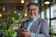 © Art Gallery - Smiling mature Latin or Indian businessman holding smartphone in office. Middle aged manager using cell phone mobile app. Digital technology application and solutions for business, Generative AI