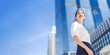 © dodotone - Portrait of successful business asian woman standing looking forward at outdoors in city