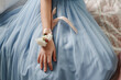 © TrueFrame Collective - Elegant light blue dress with delicate flower corsage on wrist capturing soft and graceful style