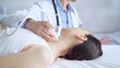 © volha_r - Doctor man is using ultrasound equipment on neck of female patient lying down for a medical examination. Medicine and science