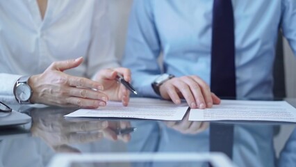 Wall Mural - Diverse business people discussing contract papers before signing. Teamwork of lawyers are at work at the glass desk in office