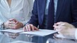 © volha_r - Business people and lawyers a contract papers before signing the agreement. Teamwork concept