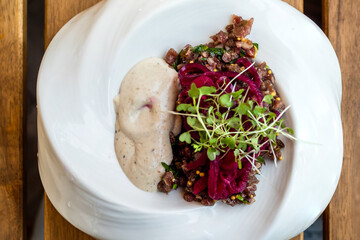 meat and vegetable salad in plate on wooden table