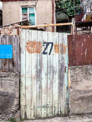 Wall Mural - shabby gate of urban house on street in Tbilisi