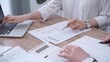 © volha_r - Professional female bookkeeper or auditor are working on business finances with a colleague, using calculator and laptop. Finance audit and taxes