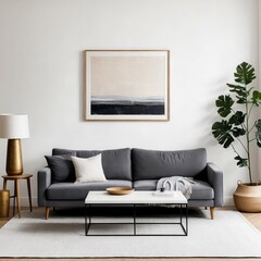 A living room with a grey couch, a coffee table, and a potted plant. The couch is covered in pillows and a blanket, and there is a bowl on the coffee table. The room has a modern and cozy feel