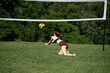 © vallejo123 - Volleyball player diving to pass the ball during a grass doubles game