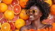 © ProPhotos - Happy African American woman wearing sunglasses smiling widely surrounded by colorful lemon and orange slices capturing a lively and fun moment against a fruity background.