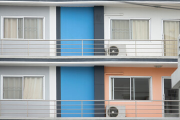 Wall Mural - A row of apartment buildings with blue and orange walls. The blue wall is on the left side of the building and the orange wall is on the right side