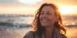 © Ace64 Studio - Happy 40 year old woman on the beach smiling with serenity