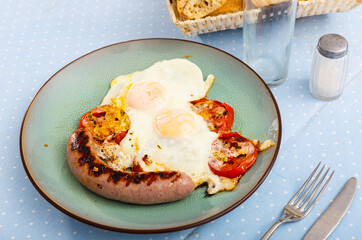 Wall Mural - Fried eggs with tomato served with homemade meat sausages