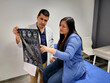 © Arlette - Male doctor specialist neurologist shows brain skull tomography to brunette Latin woman patient in hospital office