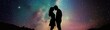 © Jiraporn - A romantic silhouette of a couple kissing under a starry night sky, creating a magical and dreamy atmosphere.