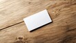 © chayantorn - A blank business card placed on a rustic wooden table, ideal for branding or personal introduction., 3D illustration