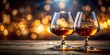 © Nasnunt - Two glasses of cognac in backlight with selective focus, cognac, drink, alcohol, glasses, backlight, selective focus