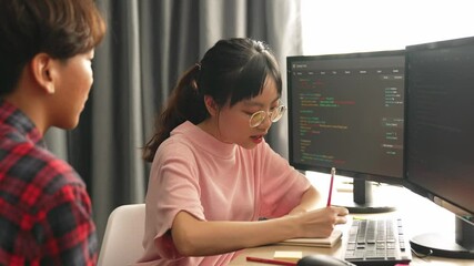 Slow motion back end software developer engineer for computer programming working together on debugging writing computing code, solving complex algorithms display on monitor in office. Burgeoning