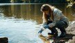 © Mikki Orso - Female biologist collects water samples from lake for environmental testing and quality analysis