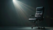 © MDShah - An office chair under the spotlight. Black background