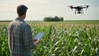 © NATTAWUT - A drone flying over a cornfield while a farmer monitors it with a tablet