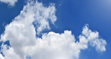 Light blue sky and white clouds. With copy space.