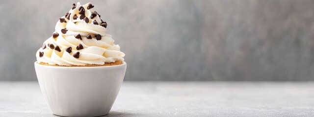 Sticker -  A cupcake, crowned with whipped cream and chocolate sprinkles, sits atop a pristine white plate on a table