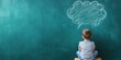 © Ahmad - Young boy thinking with a thought bubble drawn on a green chalkboard
