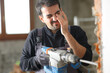 © Antonioguillem - Construction worker with debris in an eye after wrecking wall