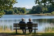 © At My Hat - Two seniors sit on a bench by a lake. Perfect for depicting peaceful retirement and tranquility.